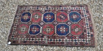 A Kazak rug, the central panel set with