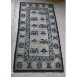 A Chinese rug, the central panel set wit