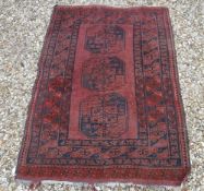 An Afghan rug, the central panel set wit