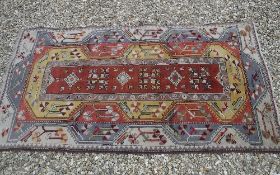 An Helas rug, the central panel set with