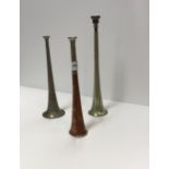 Three metal hunting horns of various siz