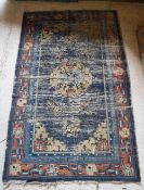 A Chinese rug, the central panel set wit