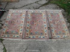 A set of three Chinese rugs, the central