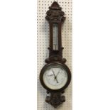 A circa 1900 oak cased barometer thermom