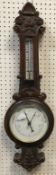 A circa 1900 oak cased barometer thermom