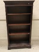 A modern mahogany bookcase with three ad