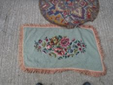 A needlework rug, the green ground set w