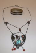 A Art Nouveau style white metal mounted coral bead and abalone shell embellished pendant of foliate