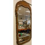 A walnut and gilt framed wall miror in the early 18th Century manner with bevel edged plate,