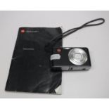 A Leica C-Lux I camera with leather case and instruction manual