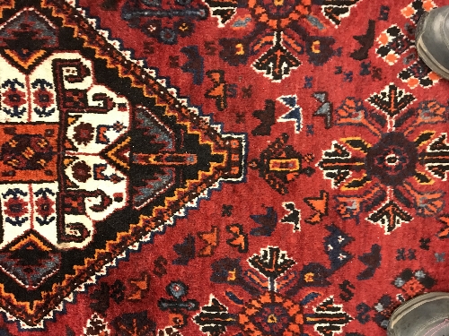 A Persian rug with centre lozenge medallion on a red ground, - Image 16 of 17