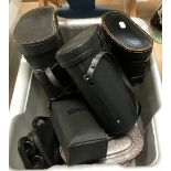 A box containing various binoculars including Paramount 8 x 25, Tohyoh 8 x 30, Tronic 8 x -24 x 50,