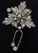 A Belle Epoque style diamond encrusted flowerhead brooch, the centre stone approx. .