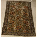 An Afshar rug, the central panel set with rose design on a cream ground, within a stepped blue,