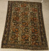 An Afshar rug, the central panel set with rose design on a cream ground, within a stepped blue,