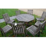 A slatted teak octagonal folding table together with matching slatted teak chairs,