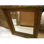 A pair of early 20th Century giltwood and gesso framed rectangular wall mirrors with all over