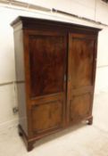 A late George III mahogany two door cupboard,