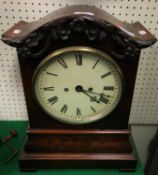 An early Victorian mahogany cased mantel clock with oak leaf and acorn decorated cornice over the