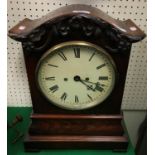 An early Victorian mahogany cased mantel clock with oak leaf and acorn decorated cornice over the