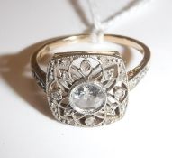 A 14 carat yellow and white gold mounted filigree design dress ring of rounded square form,