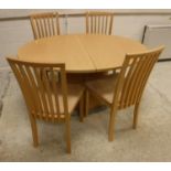 A Skovby pale beech oval extending dining table on oval centre pedestal,