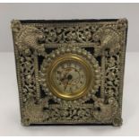 A Victorian mantel clock with pierced plated decoration enclosing the dial with fairy and dragonfly