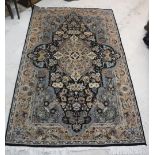 A Persian design rug with centre medallion on a blue black ground,