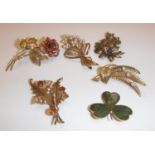 A collection of five 9 carat gold mounted brooches one as a pink and yellow gold rose, 5 cm long,