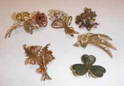 A collection of five 9 carat gold mounted brooches one as a pink and yellow gold rose, 5 cm long,