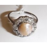 A white gold mounted pearl and diamond dress ring, the central pearl (approx size 8),
