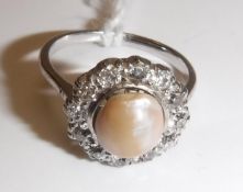 A white gold mounted pearl and diamond dress ring, the central pearl (approx size 8),