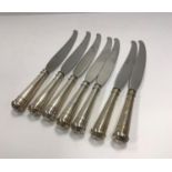 A set of seven Continental knives with white metal handles in the Art Deco taste