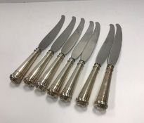 A set of seven Continental knives with white metal handles in the Art Deco taste