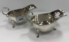 A pair of silver sauceboats, raised on hoof feet (by Charles S Green & Co. Ltd, Birmingham 1945), 6.