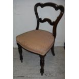 A set of six Victorian rosewood shaped balloon back dining chairs with upholstered seats on