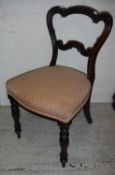 A set of six Victorian rosewood shaped balloon back dining chairs with upholstered seats on