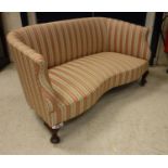 An early 20th Century upholstered scroll arm salon sofa with shaped front rail raised on squat