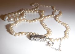 A natural saltwater pearl single strand necklace with diamond clasp,