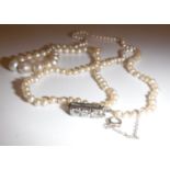 A natural saltwater pearl single strand necklace with diamond clasp,