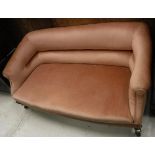 An early 20th Century upholstered salon sofa with scroll arms on cabriole front legs,