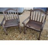 Two modern teak slatted wooden garden armchairs