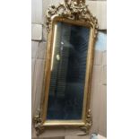 A 19th Century carved giltwood and gesso framed pier glass with ornate scrolling foliate decoration