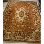 An Oriental carpet, the central panel set with foliate decorated medallion on a gold ground,