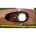 A plywood single seat canoe and paddles,