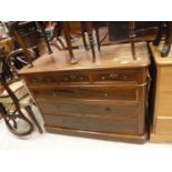 A mahogany chest of three short over three long drawers with flush brass handles raised on a plinth