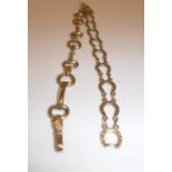 A 9 carat gold snaffle bit bracelet, 19 cm long and a 9 carat gold horseshoe link bracelet,
