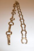 A 9 carat gold snaffle bit bracelet, 19 cm long and a 9 carat gold horseshoe link bracelet,