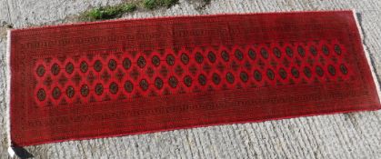 A Tekke Bokhara rug with all-over elephant foot medallion on a red ground,