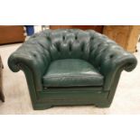 A pair of green buttoned leather upholstered scroll arm chairs with studded show frame front on